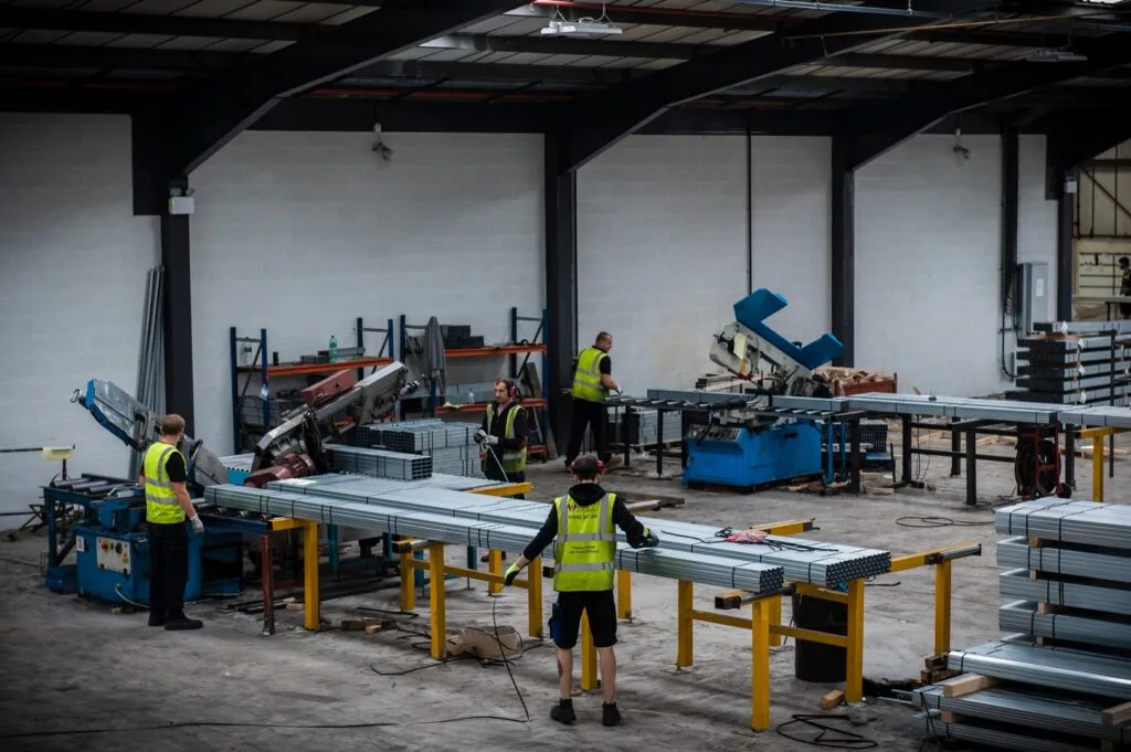Northwest Metal Sections factory floor with the team working around production machinery and metal sections